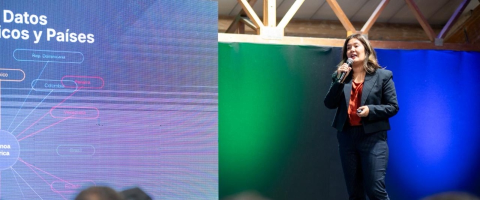 Mujer expone sobre Latam GPT y datos regionales en escenario tecnológico enfocado en inteligencia artificial latinoamericana.